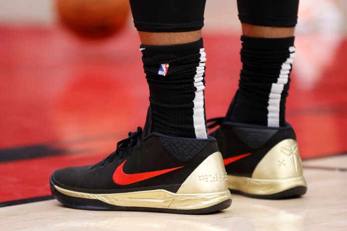 View of black, red, and gold Nike Kobe shoes.